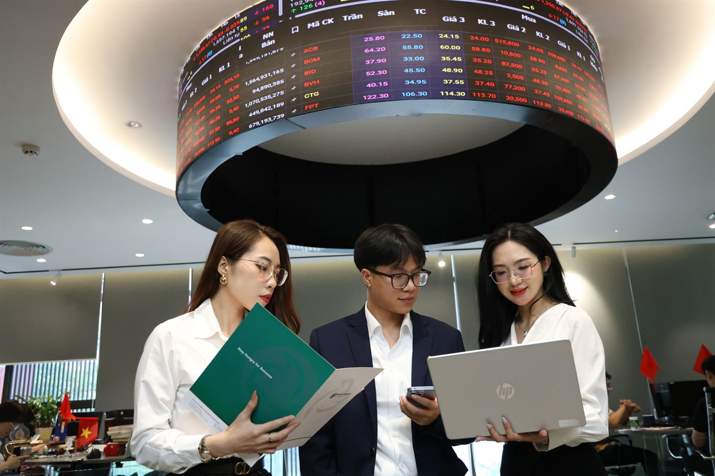 Smart Invest leaders shaking hands in front of the company logo
